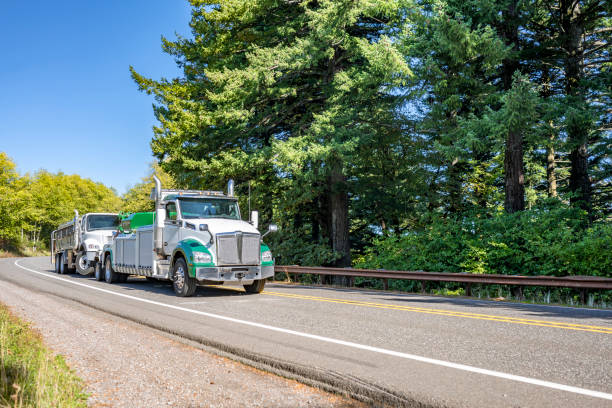 Skilled tow operator securing commercial pickup carefully in tight business parking lot access lane, Skilled tow operator securing commercial pickup for safe transport to repair shop, Fleet Towing team securing a disabled contractor pickup beside a Littleton - CO commercial property